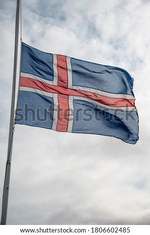 Iceland flag against a cloudy sky in Iceland.