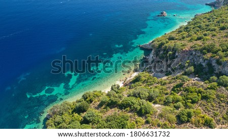 Aerial photo taken by drone of Caribbean tropical exotic steep cliff island bay visited by yachts with turquoise clear sea sandy beaches and rare limestone trees