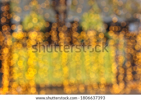 Bokeh circles are long yellow vertical lines. From the lights in a temple fair in Thailand