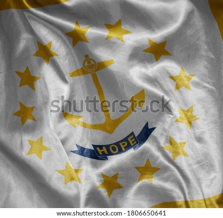 waving colorful shining big flag of rhode island state on a silky texture