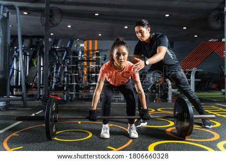 Personal trainer teaches about exercise deadlift posture Royalty-Free Stock Photo #1806660328