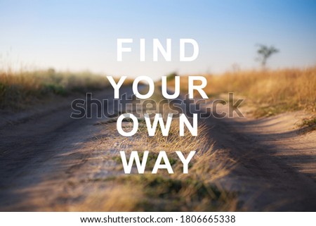 Find Your Own Way - motivational quote on road background. Shallow DOF