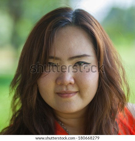 Close up of happy Asian woman outdoor in a park