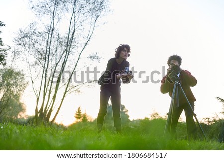 Photographer couple with camera on tripod as landscape photographer in nature