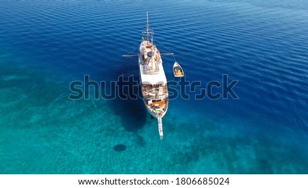 Aerial drone photo of large yacht anchored in paradise tropical exotic bay with turquoise clear sea