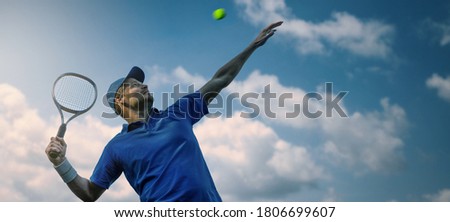 male tennis player hitting ball with racket against blue sky. banner copy space