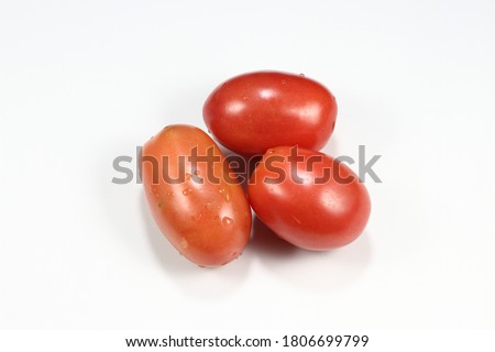 Pile of fresh and organic Cherry tomato or Plum tomato isolated on the white background. Famous ingredients in Thai local cuisine.  Royalty-Free Stock Photo #1806699799