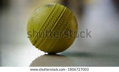 Yellow Cricket ball resting on white marble, round rubber ball. Vicky cricket ball view with attractive look. 