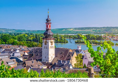 Aerial view of Rudesheim am Rhein historical town centre with clock tower spire of St. Jakobus catholic church and Rhine river, blue sky background, Rhineland-Palatinate and Hesse states, Germany Royalty-Free Stock Photo #1806730468