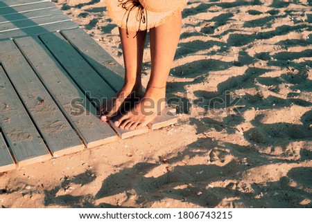girl feet, footpath on the beach