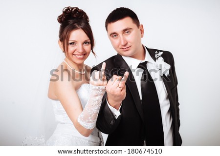 newlyweds embracing and kissing. Cute young married couple posing on white background. Bridal happy couple isolated on white background. Bouquet of flowers, wedding dress