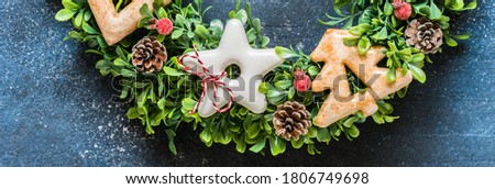 Christmas Wreath with Gingerbread Cookies, Berries and Pine Cones, banner