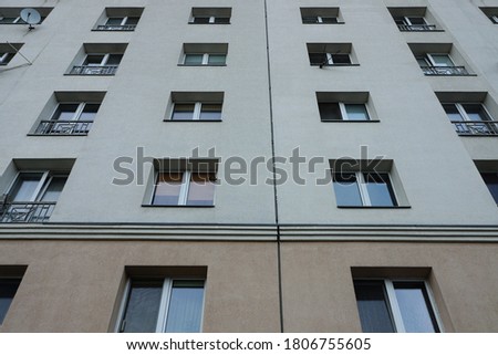 texture of a row of windows on a gray wall of a house