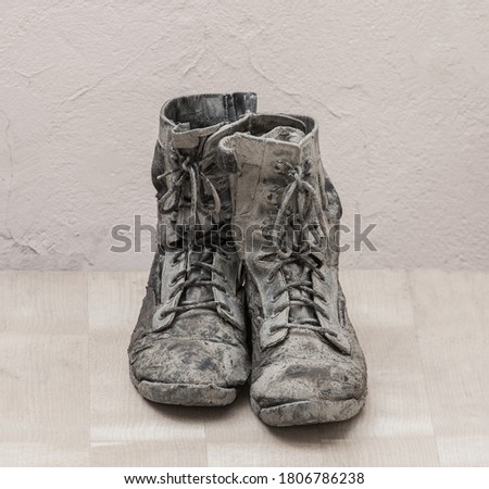 Dirty torn men's high boots close-up