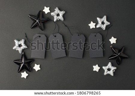 New Year 20202, Christmas Holiday seasonal sale - tags with copy space, gift box and decorations on balck background. Monochrome stylish luxury concept, banner, voucher for shopping