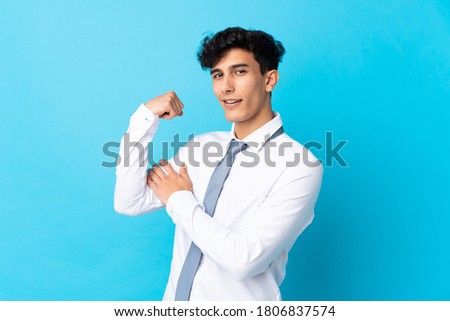 Young Argentinian businessman over isolated blue background making strong gesture