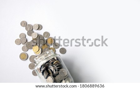 coins (Thai money) on white table with over light and soft-focus in the background Royalty-Free Stock Photo #1806889636