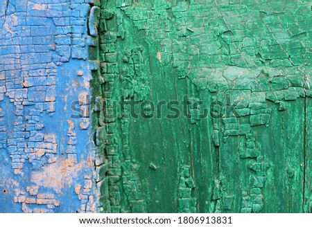 Old wooden background with remains of pieces of scraps of old paint on wood. Texture of an old tree, vintage wood background peeling paint. old blue board with cracked paint