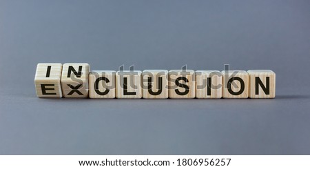 Symbol for a better inclusion. Inverted cube and changed word exclusion to inclusion. Beautiful grey background. Copy space. Royalty-Free Stock Photo #1806956257