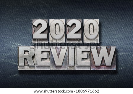 review 2020 phrase made from metallic letterpress on dark jeans background Royalty-Free Stock Photo #1806971662