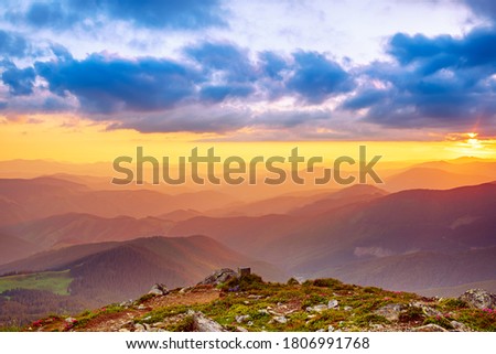 Amazing mountain landscape with colorful vivid sunset on the cloudy sky, natural outdoor travel background. Beauty world.
