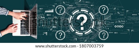 Question marks with person using a laptop computer