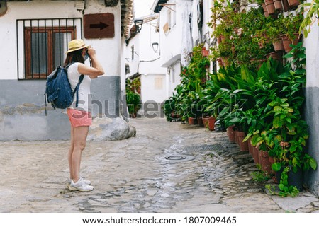 Freelance woman with mask sightseeing