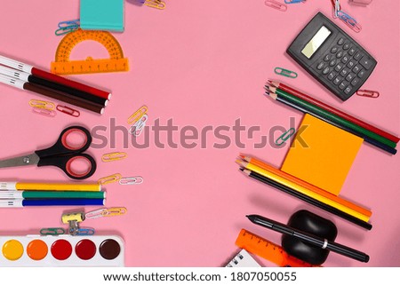 the School supplies on a pink Board. Back to school.