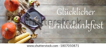 Thanksgiving Day. Thanksgiving Day Autumn background of pumpkins and leaves. Festive background and inscription on the German Glücklicher Erntedankfest meaning happy thanks giving day . View from above. Copyspace