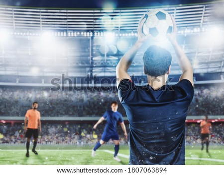 Soccer player ready to pass the ball at the stadium during a night match.