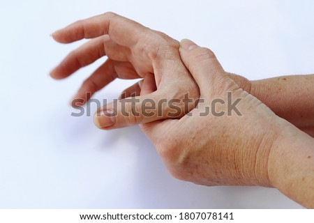 The hands of a woman with Parkinson's disease tremble very strongly Royalty-Free Stock Photo #1807078141