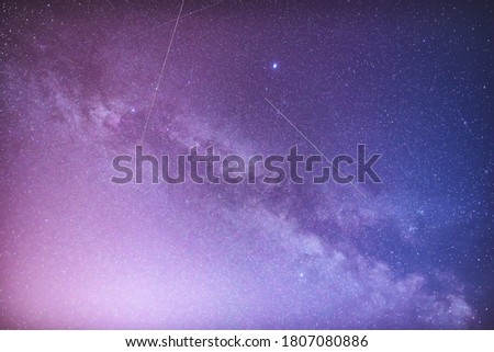 Milky Way and satellites in the night sky.