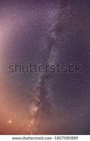 Milky Way and satellites in the night sky.