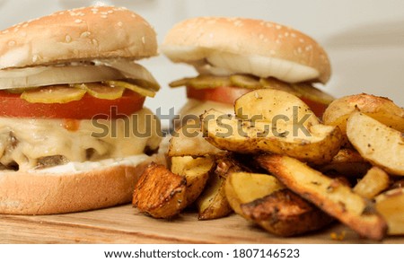 Burger with vegetables, spices and fries. Meat burger. Hamburger with a knife. Beef burger. Organic hamburger