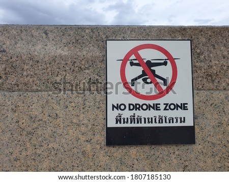 Symbol for banning drones in this area on marble walls. The Thai language in the picture refers to the area where drones are banned.