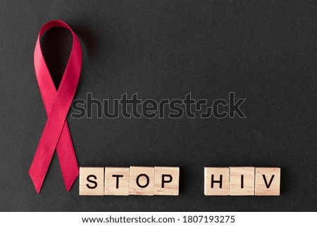 AIDS Awareness Sign Red Ribbon. word from letters.