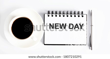 Business NEW DAY. Spiral notebook with text on white background with coffee