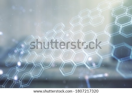 Double exposure of abstract virtual technology hologram with hexagon on modern business center exterior background. Research and development software concept