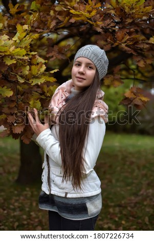 Cute long-haired Russian girl in autumn