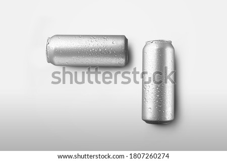 Set of big tin cans with lemonade or soda with condensate and drops, on a white background with shadows. Mockup of a carbonate bottle with an energetic or tonic, for the presentation of design,pattern
