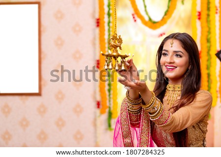 Female Celebratiing diyas Decoration  for diwali festival. Royalty-Free Stock Photo #1807284325