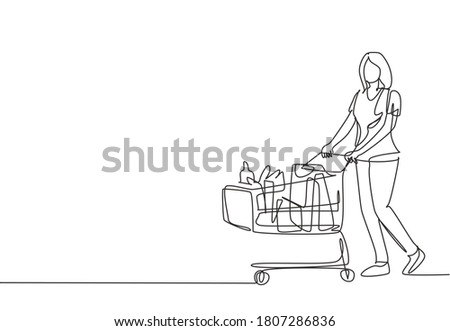 One continuous line drawing young happy female pushing trolley at supermarket while shopping fruits, vegetables, breads, milk. Shopping in hypermarket concept. Single line draw design illustration Royalty-Free Stock Photo #1807286836