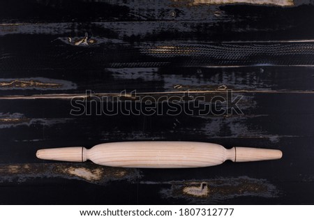 kitchen wooden rolling pin isolated on black background