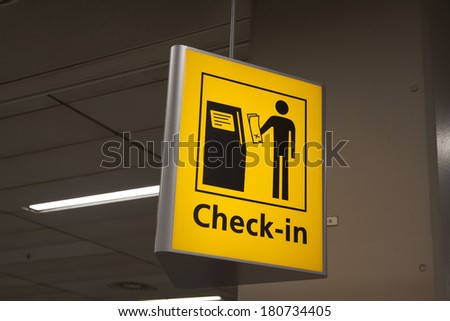 Yellow check in information sign on a airport.