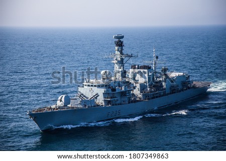 Photo of a warship at sea taken from a helicopter