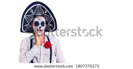 Man wearing day of the dead costume over background touching mouth with hand with painful expression because of toothache or dental illness on teeth. dentist 