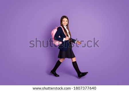 Full length body size profile side view of her she attractive cheerful small little schoolchild going back to school new season semester isolated violet lilac purple pastel color background Royalty-Free Stock Photo #1807377640