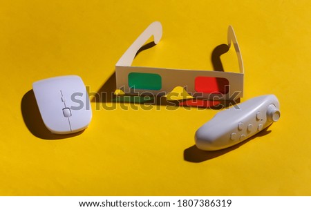 Anaglyph 3D glasses, pc mouse and joystick on yellow background with a shadow. Pop Art.