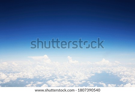 Blue sky background and white clouds soft focus, top view take a picture on airplane