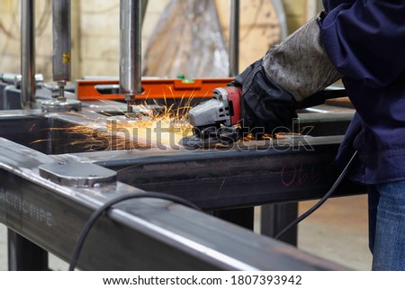 Metal workers use manual labor. Skilled welder.Technicians use steel cutting tools to cut steel. Metal cutting. Close up hand worker electric saw wheel grinding cutting
 a steel in factory.  Royalty-Free Stock Photo #1807393942